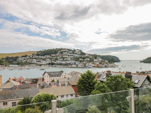 A coastal town with houses on a hillside overlooking a harbor with boats and water at 13 Above Town in Dartmouth