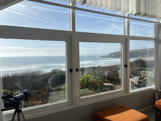 A conservatory with a view of the ocean at Stonecroft in Praa Sands