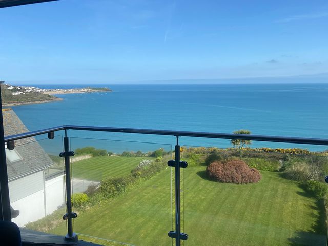 A coastal view from a balcony overlooking the sea and garden at 5 St Gwithian Apartments in Carbis Bay