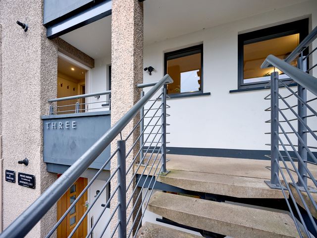 An exterior view of an apartment entrance with stairs at Riverside Park 3 Keswick