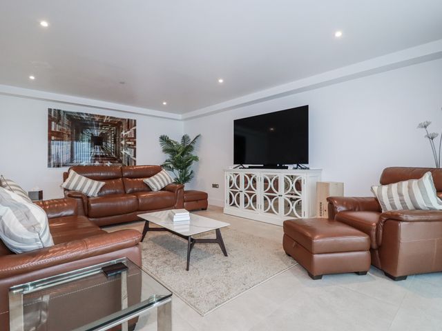 A living room with a sofa and television at 13 Cliff Edge in Newquay