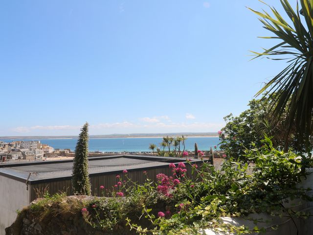 A view of water and buildings from a terrace at Heron in St Ives