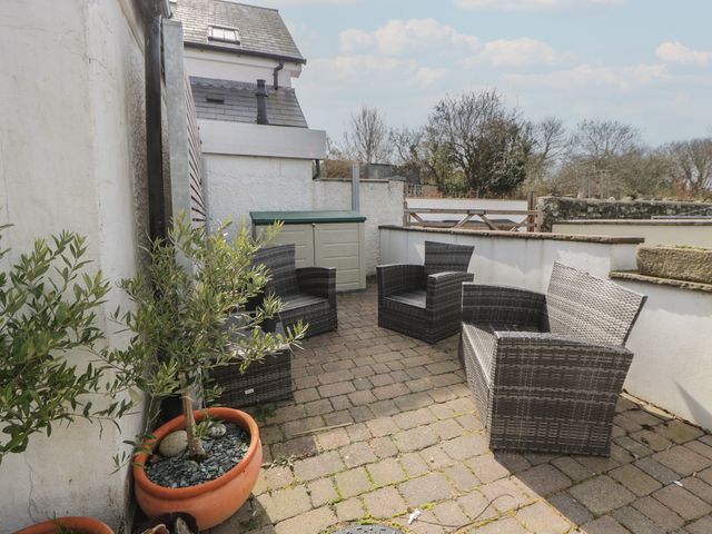 An outdoor area with chairs and a storage box at Awen Ingli, Newport, Pembrokeshire