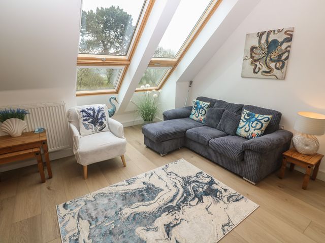 A living room with a sofa and armchair at Upper Deck in Truro