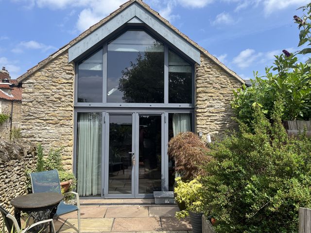 An outdoor area with glass doors and plants at The Nail Shed East Ayton