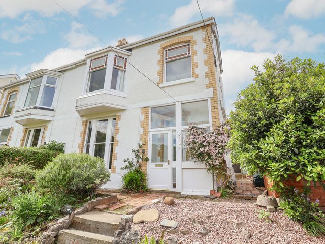 The front exterior of a semi detached house with a porch and garden at 18 Ffordd Tanrallt in Prestatyn