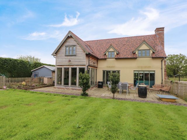 An outdoor area with a house and garden at Gayton Stables in Heswall