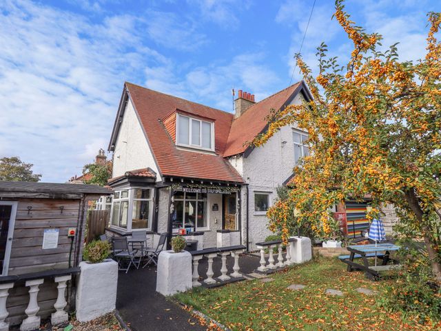 A house with a garden and furniture outside at Telford Lodge in Skegness
