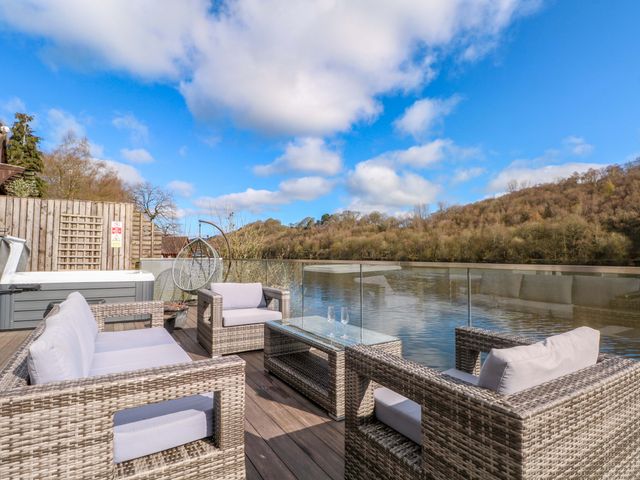 An outdoor seating area overlooking water at The Bothy in Leek