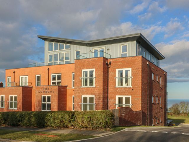 A modern building with balconies and a sign The Lookout