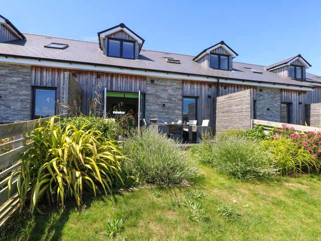 An outdoor space with a house and garden at Overcombe Mill in Nottington near Weymouth