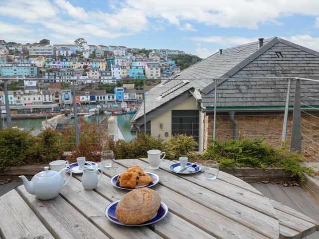 An outdoor dining setup with tea and pastries at Bay View in Brixham