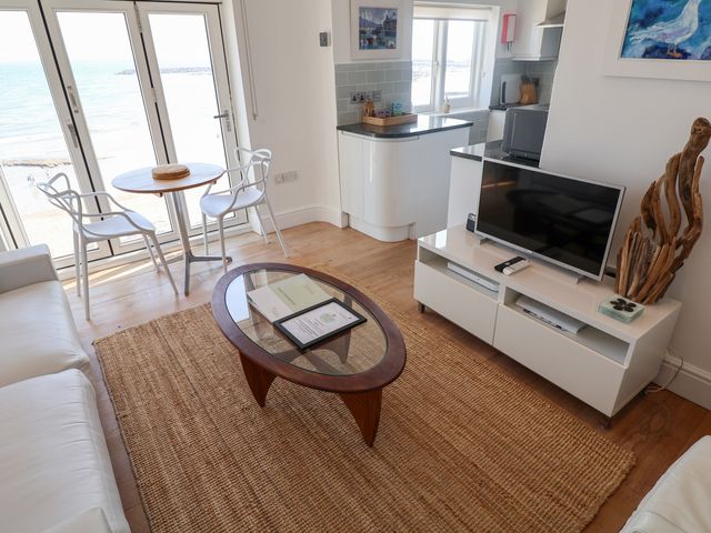 A living room with a view of the sea at Seagull in Lyme Regis