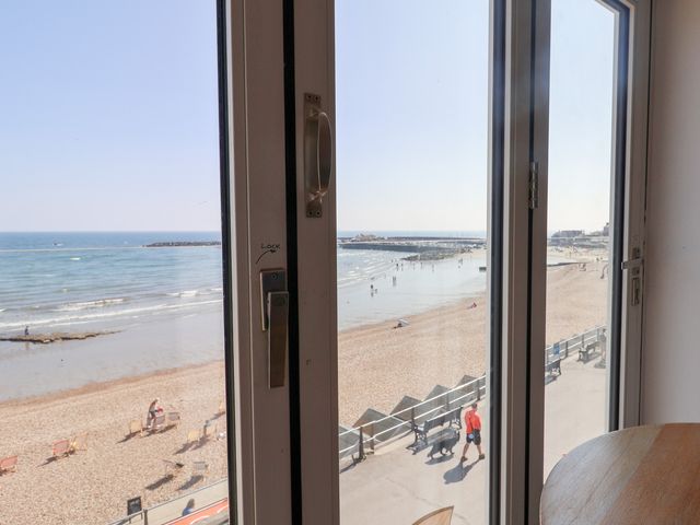 A view of the beach and sea from a window at Seagull in Lyme Regis