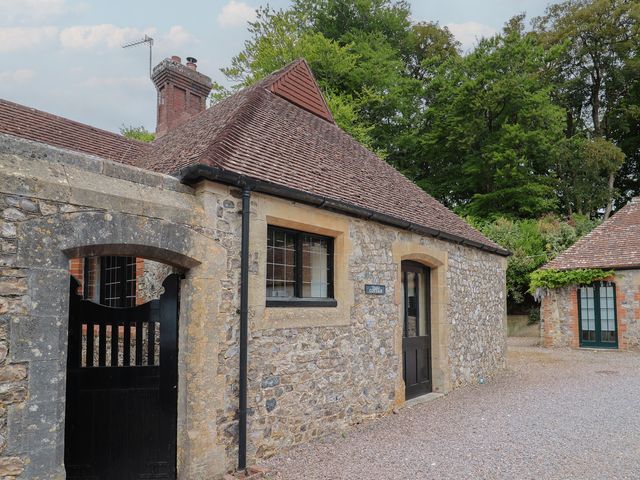 An exterior view of a stone cottage with a door and window at Yard Cottage Rousdon
