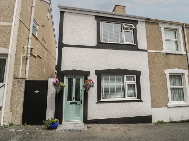 A house with a front door and flower pots at 4 Haven Villas in Conwy