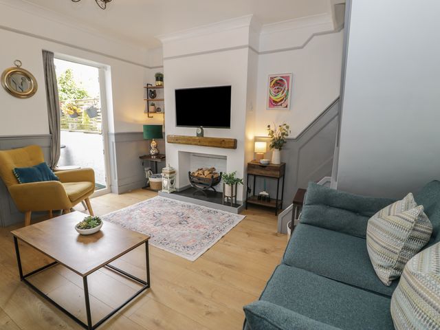 A living room with a sofa and television at 4 Haven Villas in Conwy