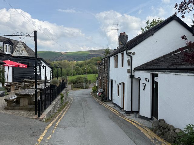 An outdoor view of Triangle Inn and surrounding scenery in Rhayader