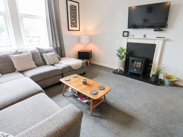 A living room with a sofa and coffee table at Marden Mews Whitley Bay