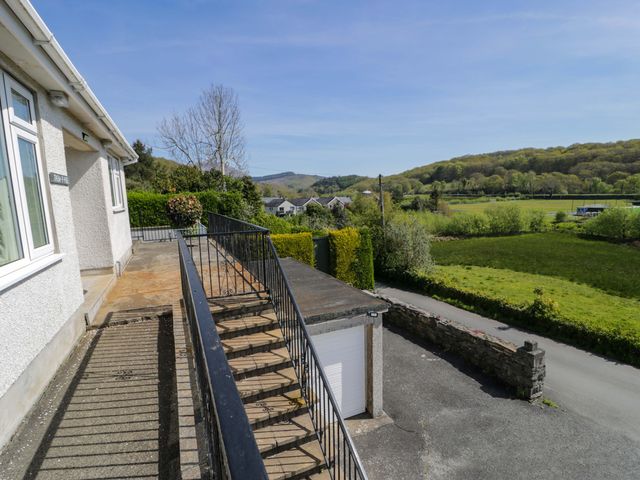A staircase and garage with fields and trees at Trem Y Foel in Penrhyndeudraeth