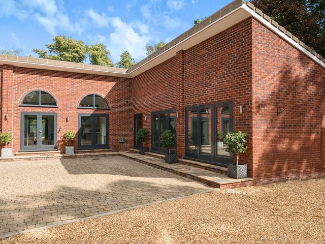 An outdoor area with brick walls and pathways at The Cottage in Wimborne Minster