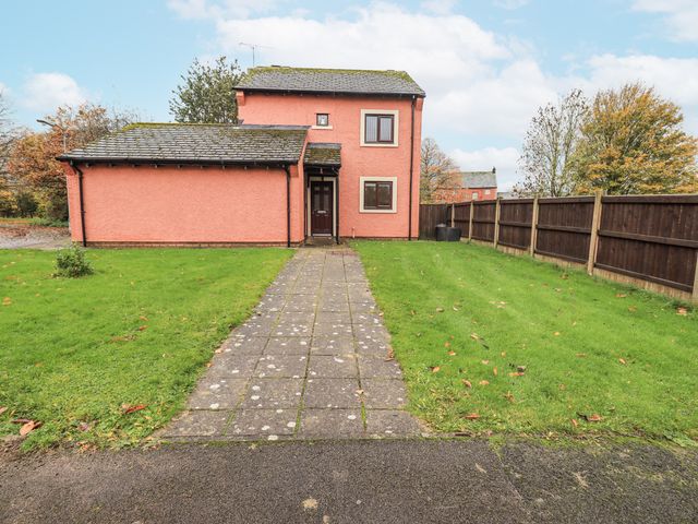 A house with a pathway and grass yard at 1 Eamont Park in Penrith