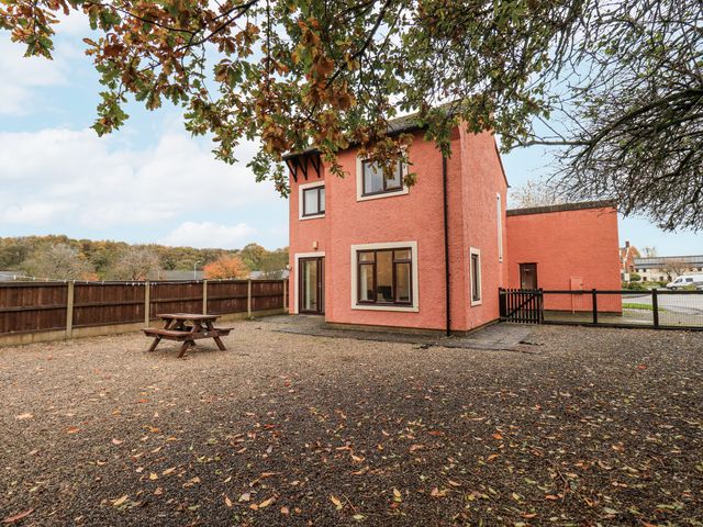 A house with a picnic table and trees at 1 Eamont Park Penrith