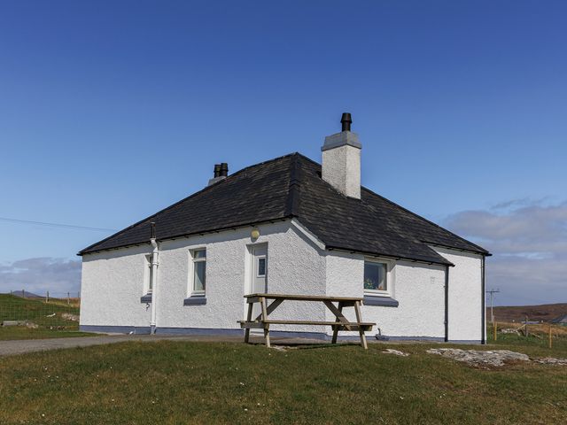 A house with a table outside at Dun Buidhe in South Boisdale near Daliburgh, Isle Of South Uist