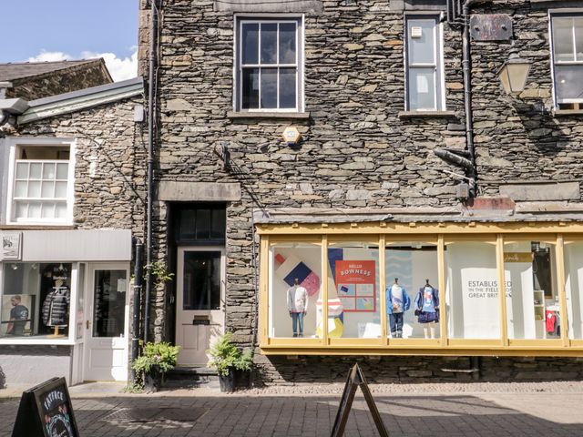 Shopfront with stone walls and mannequins in display windows at Bowness Central in Bowness-On-Windermere