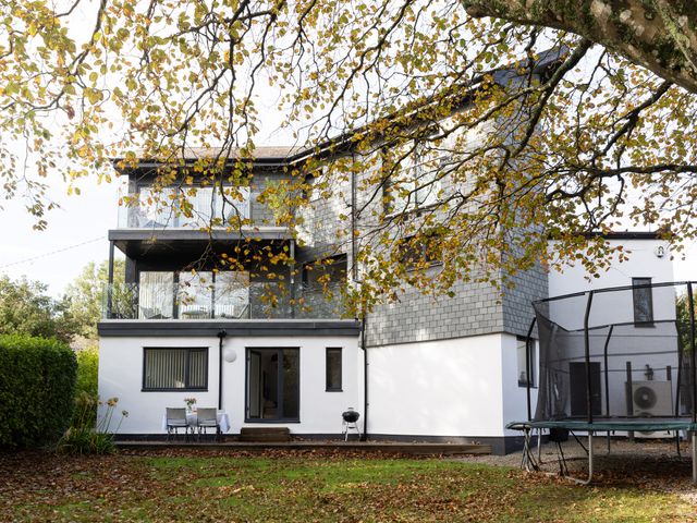 The exterior view of a house with a balcony and patio at Estuary Watch Lelant near Carbis Bay
