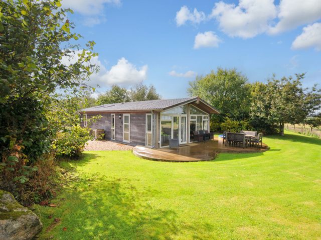 A house with a deck and outdoor furniture at 8 Horizon View Dobwalls