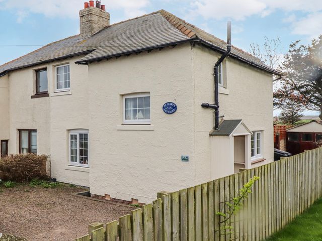 An exterior view of a house with a fence at St Marys Cottages No4 Low Newton-by-the-Sea