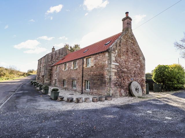 A house with a gravel pathway and plants at Millstone in Lucker