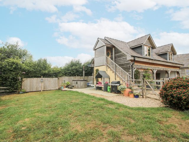 An outdoor space with a barbecue and garden at Stable Cottage in Norbury near Bishop's Castle