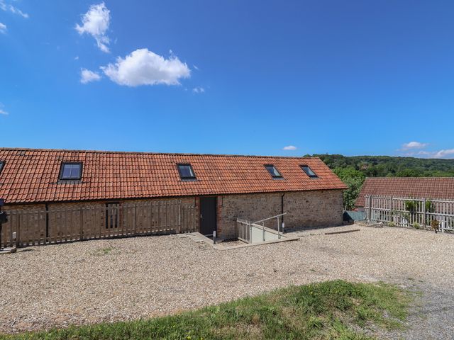 An outdoor view of a building with a gravel area at The Stables in Uplyme