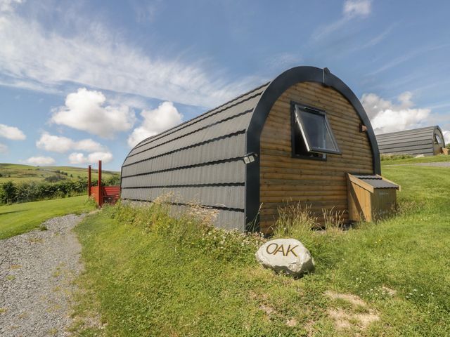 A cabin with a window and rock sign at Oak in Ulverston