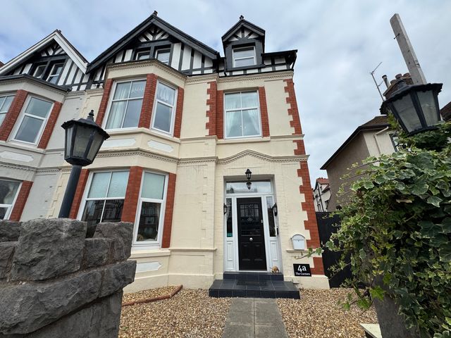 A house with a black front door and windows at The Causeway 