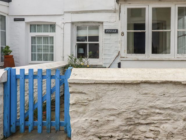 An exterior view of a house with a blue gate and a sign at Penvar in Truro