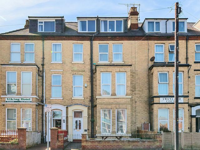 A row of brick buildings with multiple windows including Viking Hotel and Swanland Court at Bridlington Bay House in Bridlington