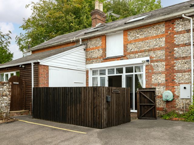 An outdoor view of a building with windows and a fence at Primrose in Blandford Forum