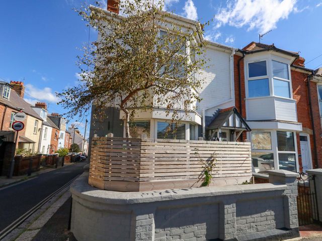 A house with a tree and fence at The Old Post Office in Weymouth