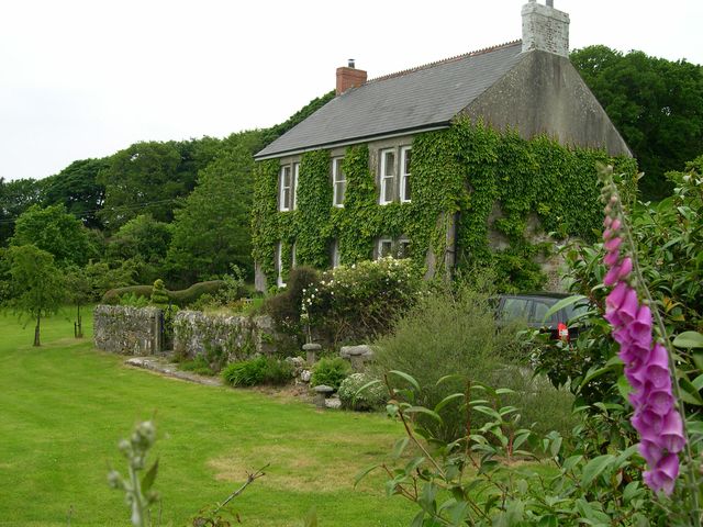 A house surrounded by garden and trees at Treveddoe Farmhouse Bodmin Moor