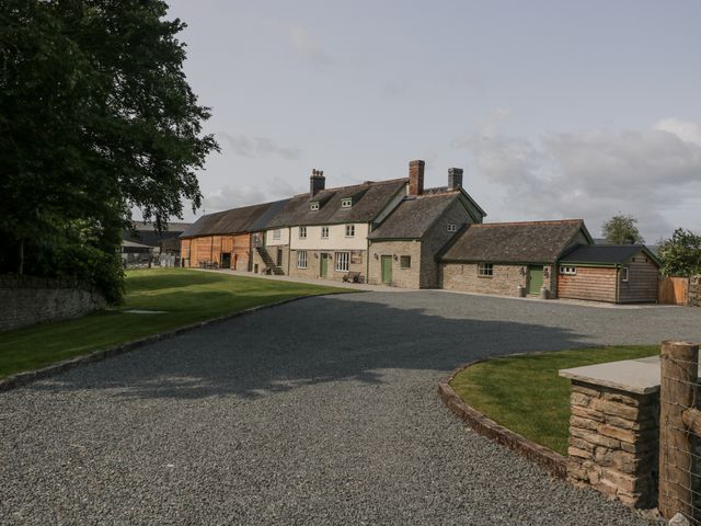An outdoor view of a house with a gravel driveway at Evenjobb Court Farmhouse Evenjobb near Presteigne