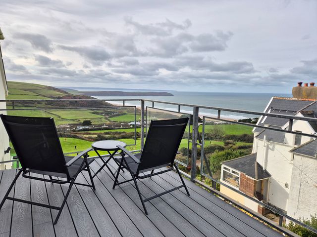 A balcony view with chairs and table at 5 Seymour Villas Woolacombe