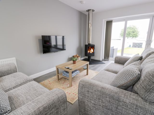A living room with a sofa and coffee table at Beach House in Stranraer