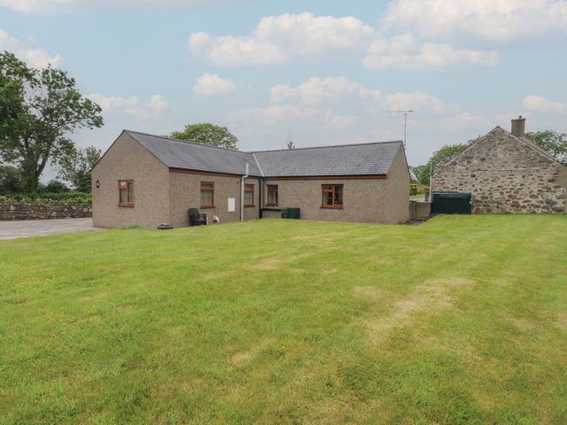 A house with a garden and trees at Bryn Caled in Llanarmon near Y Ffor
