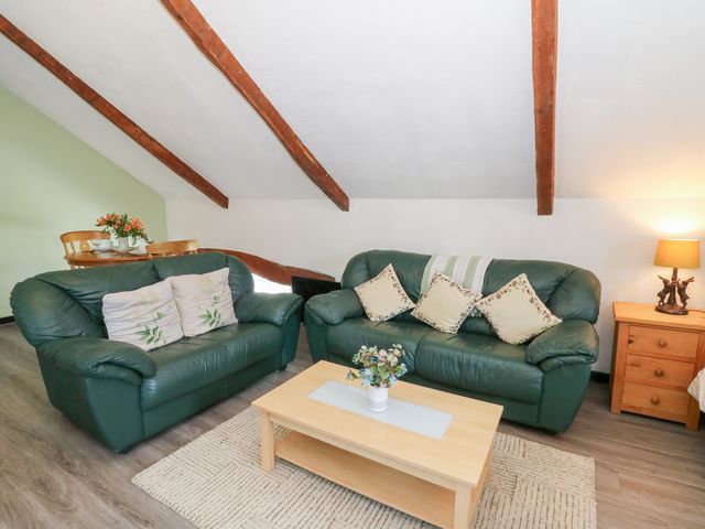 A living room with sofas and a coffee table at Loft apartment in Llandysul