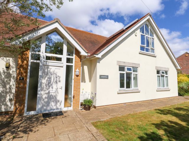 A house with windows and a pathway at 1 Fernhill Avenue Weymouth