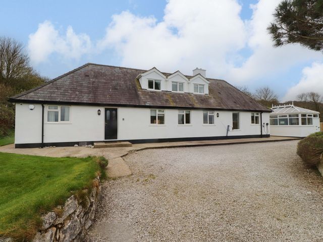 A house with a gravel pathway and garden at Belan Wen in Llanddona near Pentraeth