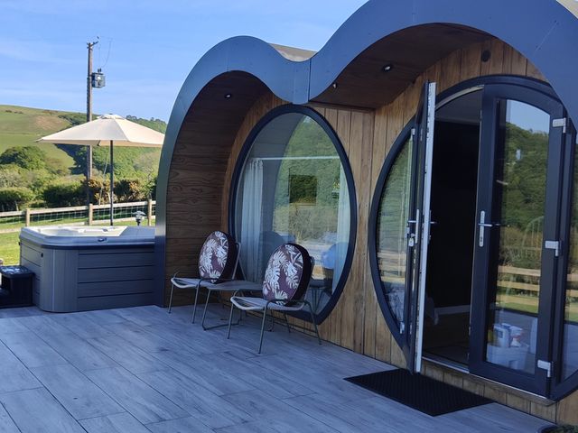 An outdoor area with a hot tub and chairs at Ceunant in Llanfihangel-y-Creuddyn near Aberystwyth